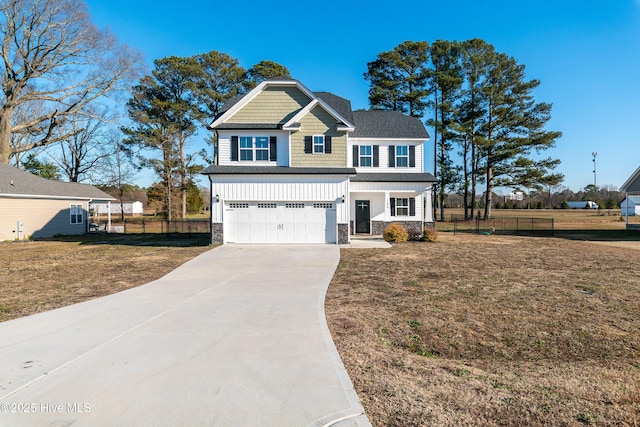 view of front of home featuring a garage and a front yard