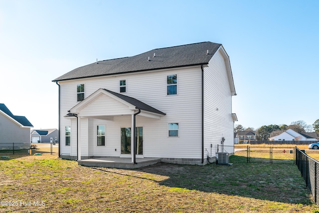 rear view of house featuring cooling unit, a yard, and a patio area