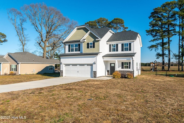 view of front of home featuring a garage and a front lawn