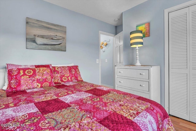 bedroom featuring light hardwood / wood-style flooring and a closet