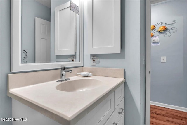 bathroom with vanity and wood-type flooring