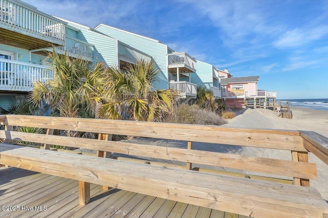 view of home's community featuring a water view and a beach view