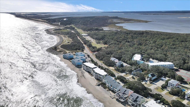 birds eye view of property featuring a water view and a beach view