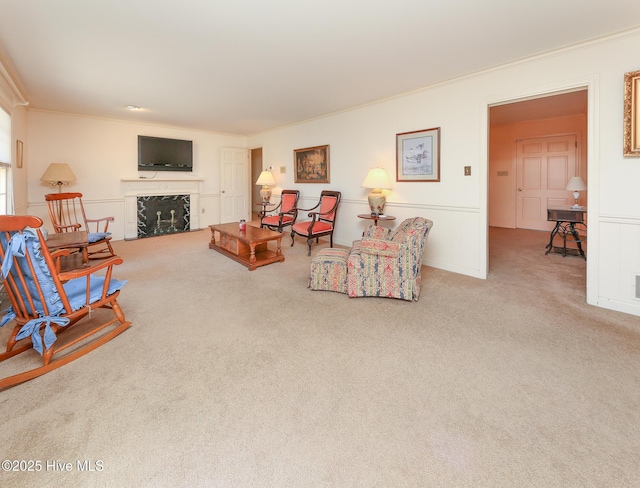 carpeted living room featuring ornamental molding and a premium fireplace