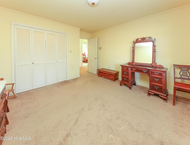 bedroom featuring light colored carpet, ornamental molding, and a closet