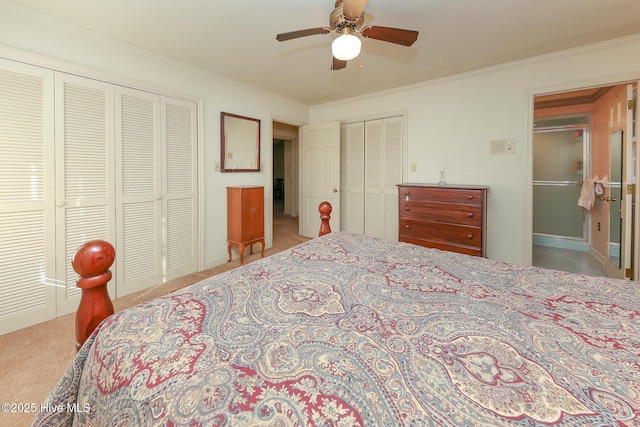 bedroom featuring ceiling fan, crown molding, and two closets