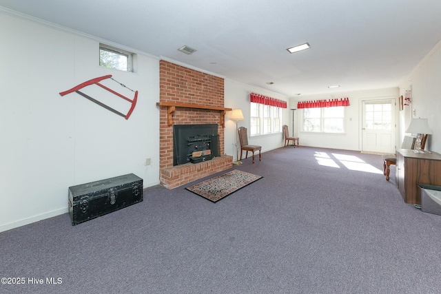 living room with a fireplace, carpet floors, and crown molding