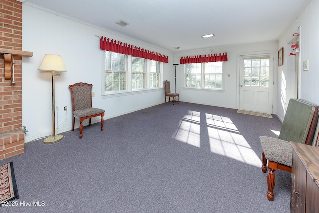 sitting room featuring dark carpet and crown molding