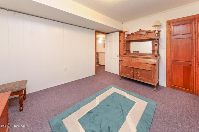 unfurnished bedroom with dark colored carpet