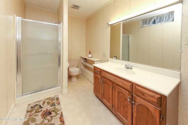 bathroom featuring vanity, toilet, an enclosed shower, and crown molding