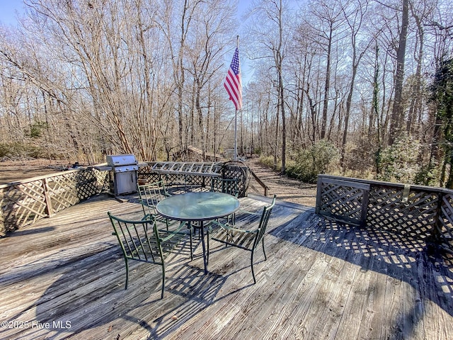 wooden deck featuring a grill