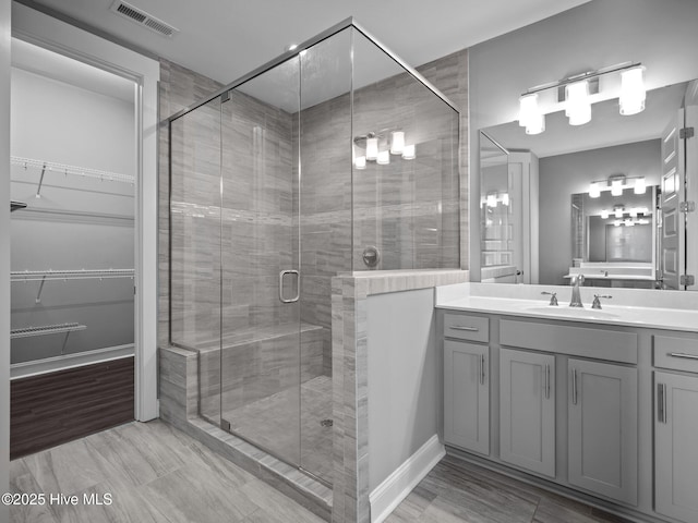 bathroom with vanity and a shower with shower door