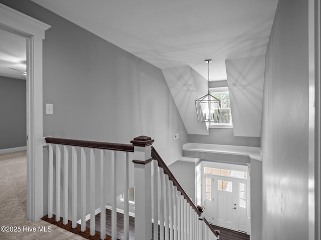 foyer with a chandelier and carpet