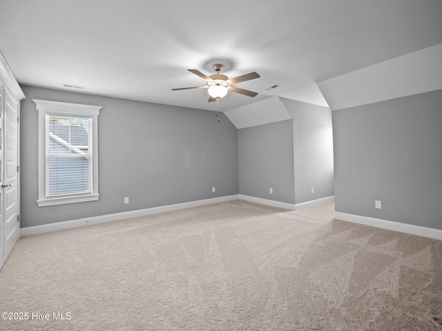 additional living space featuring ceiling fan, light colored carpet, and vaulted ceiling