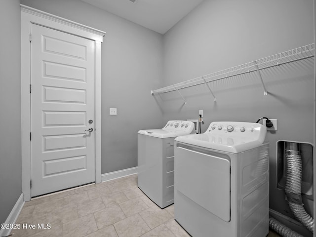 laundry area with light tile patterned floors and washer and dryer