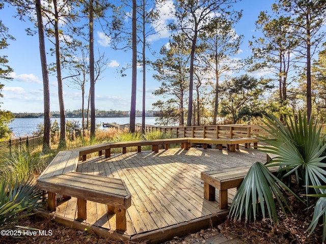 wooden deck featuring a water view