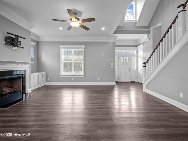 unfurnished living room featuring ceiling fan, crown molding, and dark wood-type flooring