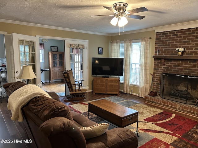 living room with ceiling fan, ornamental molding, and a textured ceiling