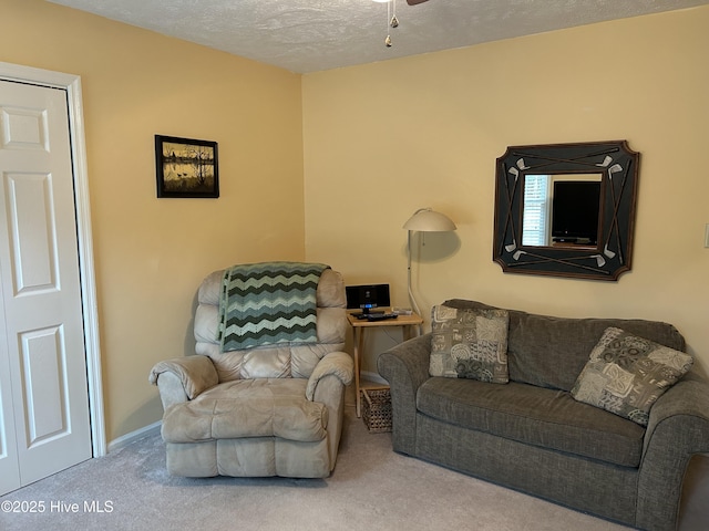 living room with carpet, a textured ceiling, and ceiling fan