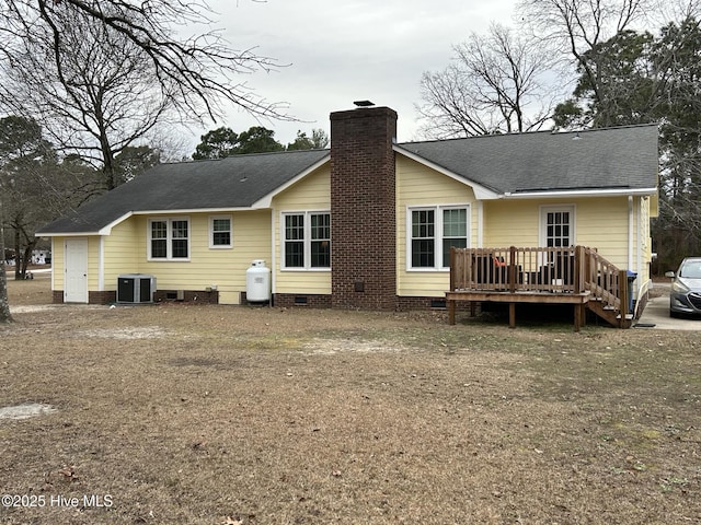 rear view of property with central AC unit and a deck