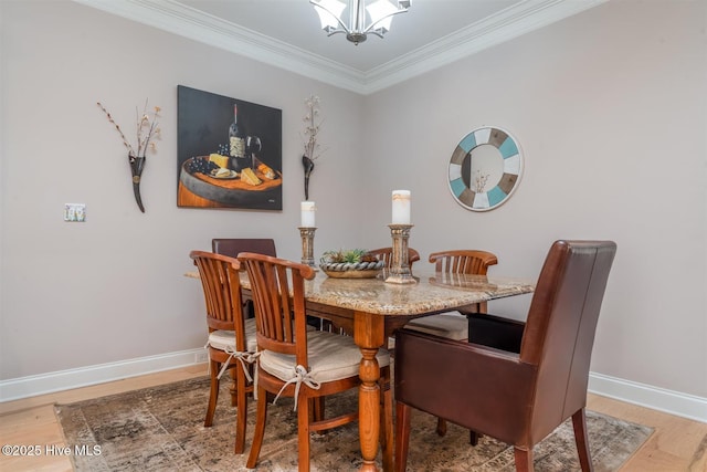 dining room featuring hardwood / wood-style flooring, an inviting chandelier, and ornamental molding