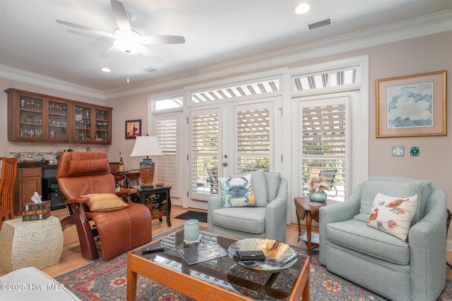 living room featuring french doors, ceiling fan, and crown molding