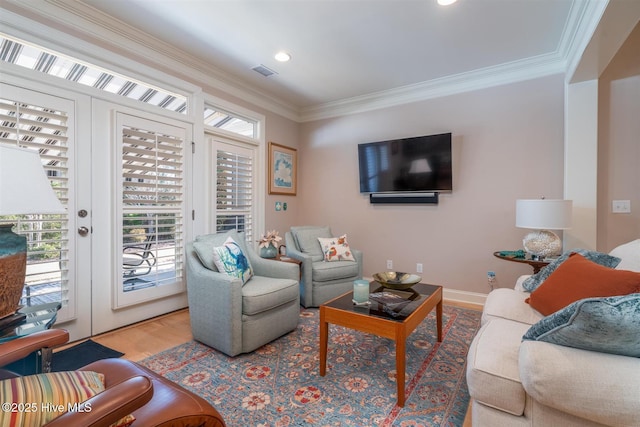 living room with light hardwood / wood-style floors and ornamental molding