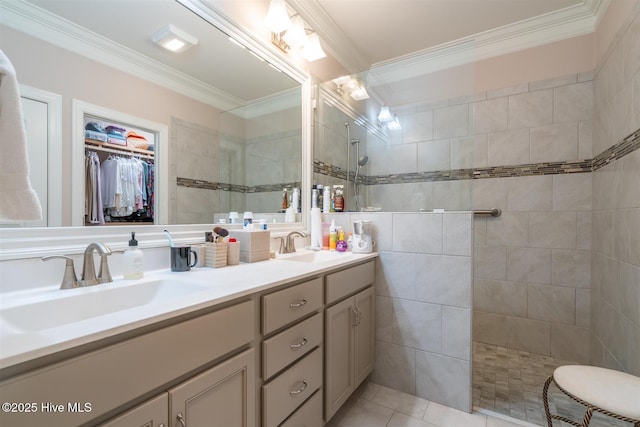 bathroom with tiled shower, vanity, tile patterned floors, and crown molding