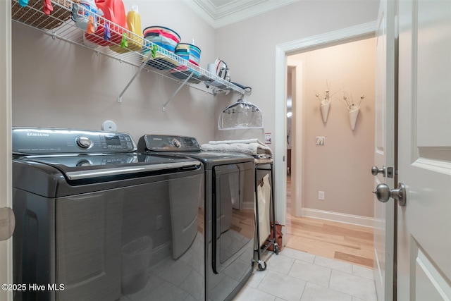 laundry room with crown molding, light tile patterned flooring, and independent washer and dryer