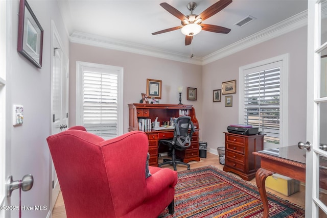 office space featuring ornamental molding, light hardwood / wood-style flooring, ceiling fan, and a healthy amount of sunlight