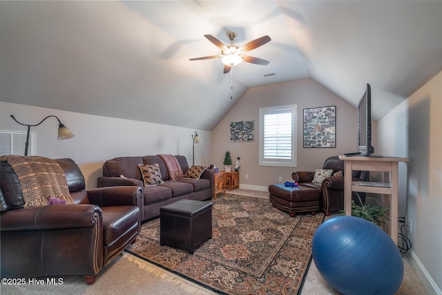 carpeted living room with ceiling fan and vaulted ceiling