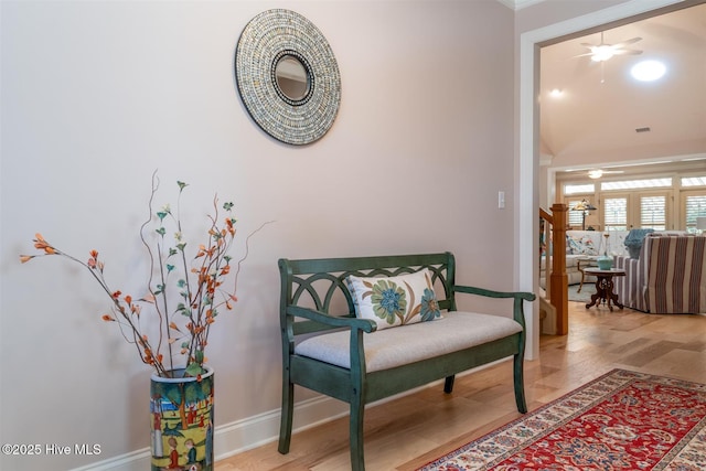 sitting room with wood-type flooring and ceiling fan