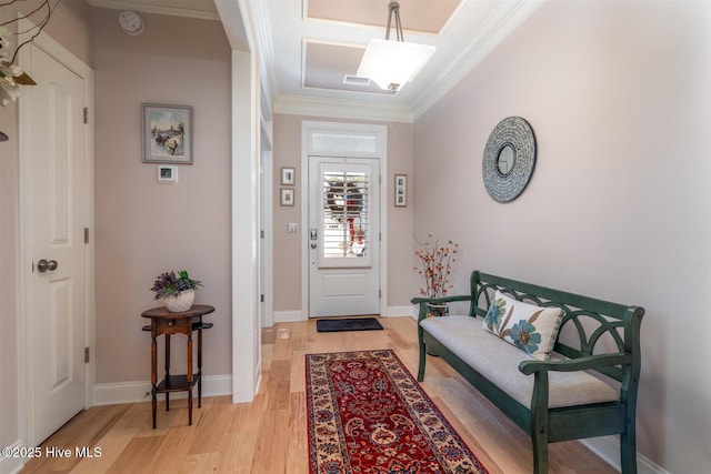 entrance foyer with light wood-type flooring and crown molding