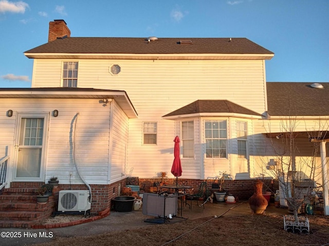 back of property featuring ac unit and a patio