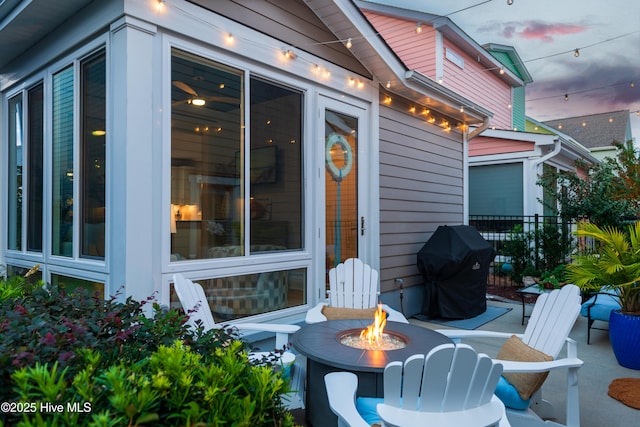 view of patio / terrace featuring fence, a fire pit, and grilling area