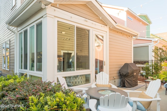 exterior space with a grill and fence