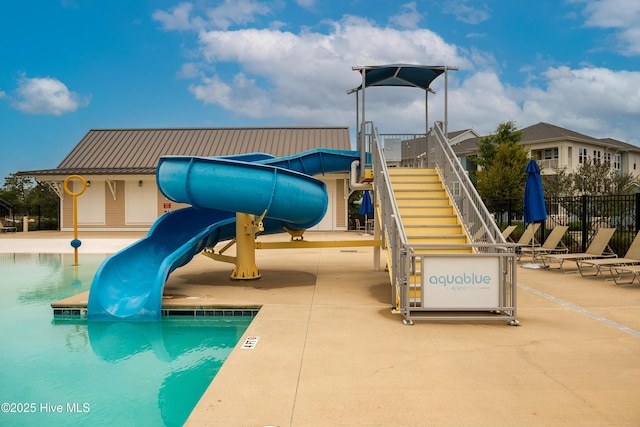 view of jungle gym with fence and a community pool