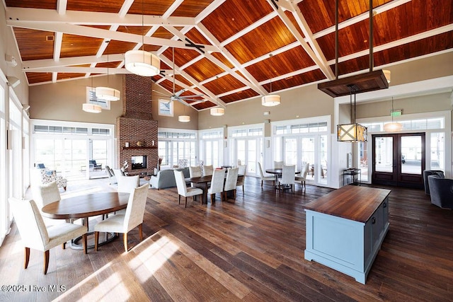 dining space featuring high vaulted ceiling, french doors, dark wood-type flooring, and wood ceiling