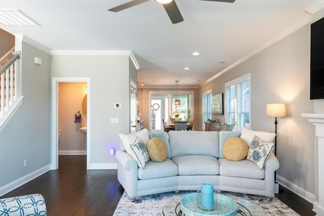 living room with visible vents, baseboards, stairs, hardwood / wood-style floors, and crown molding