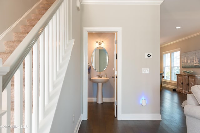 hallway with baseboards, dark wood-type flooring, and crown molding