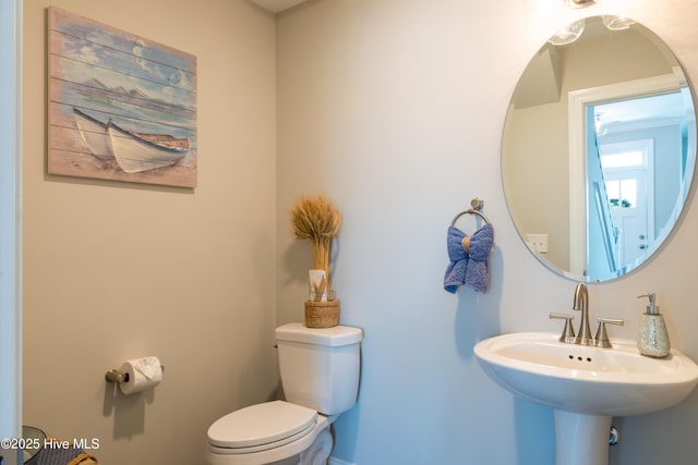 bathroom featuring toilet and a sink