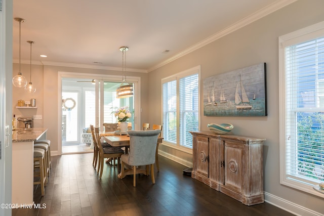 dining area with crown molding, baseboards, and dark wood-type flooring