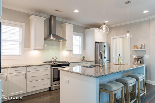 kitchen featuring wall chimney exhaust hood, appliances with stainless steel finishes, white cabinets, and dark wood-type flooring