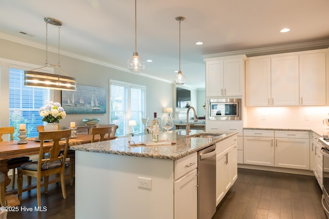 kitchen with stainless steel appliances, a sink, white cabinets, and crown molding