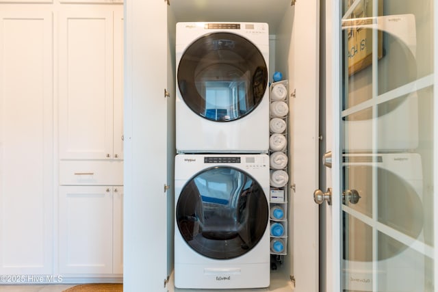 washroom with laundry area and stacked washer / dryer