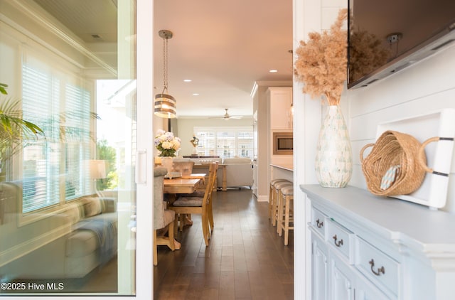 interior space featuring recessed lighting, dark wood-style flooring, and crown molding