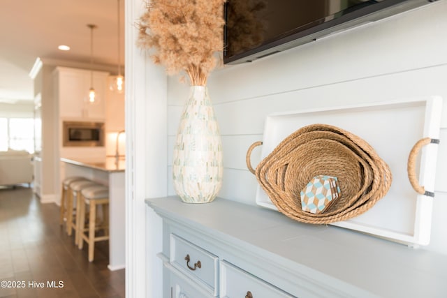 room details with stainless steel microwave, wood finished floors, and recessed lighting