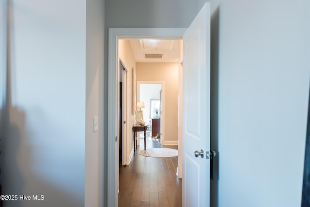 corridor featuring dark wood-type flooring and visible vents