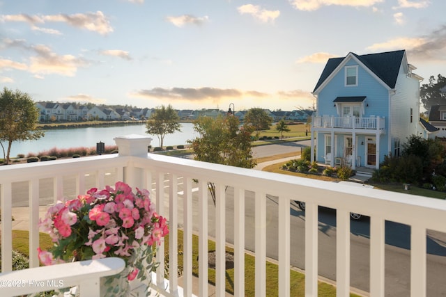 balcony featuring a water view and a residential view