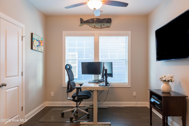 office area featuring baseboards, dark wood finished floors, a ceiling fan, and a healthy amount of sunlight